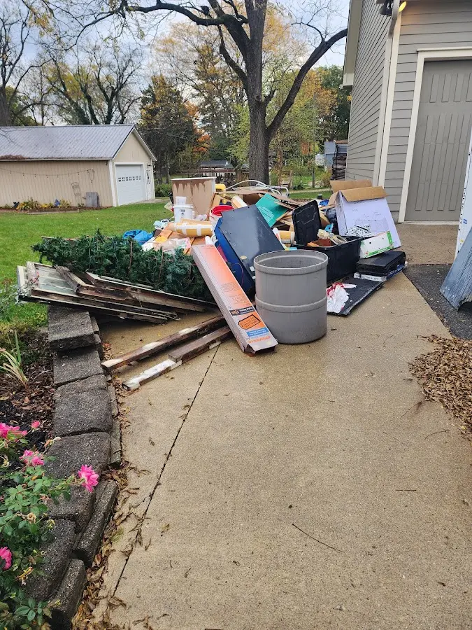 Dumpster being loaded with debris for 10 Yard Dumpster Rental in San Carlos Park